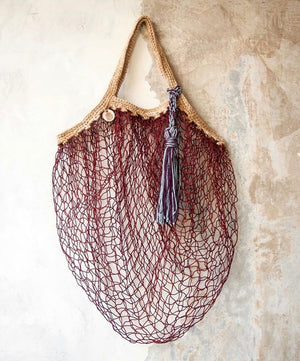bike bags made from recycled fish nets BYBBA Net Zero Rust Orange Breathable Mesh Crossbody Day Bag using waste products and providing a fair wage for the women who weave them Upcycled Fishnet Reusable Anthea Bag